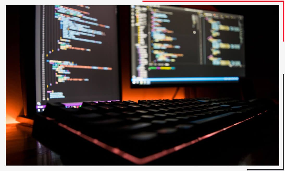 Computer with code for developing a business website in a dark environment.